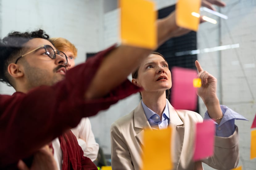 colleagues-thinking-with-post-its-side-view