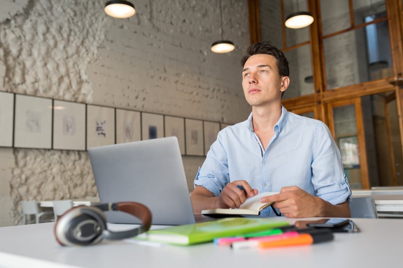 thinking-young-handsome-man-thinking-writing-notes-notebook